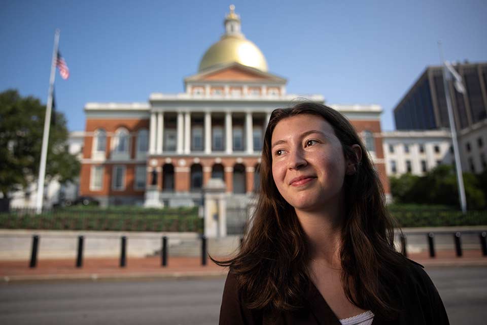 Aviva standing in front of the Massachusetts State House