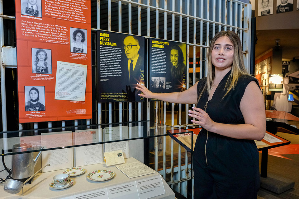 Lauren Balfour explains a museum exhibit.