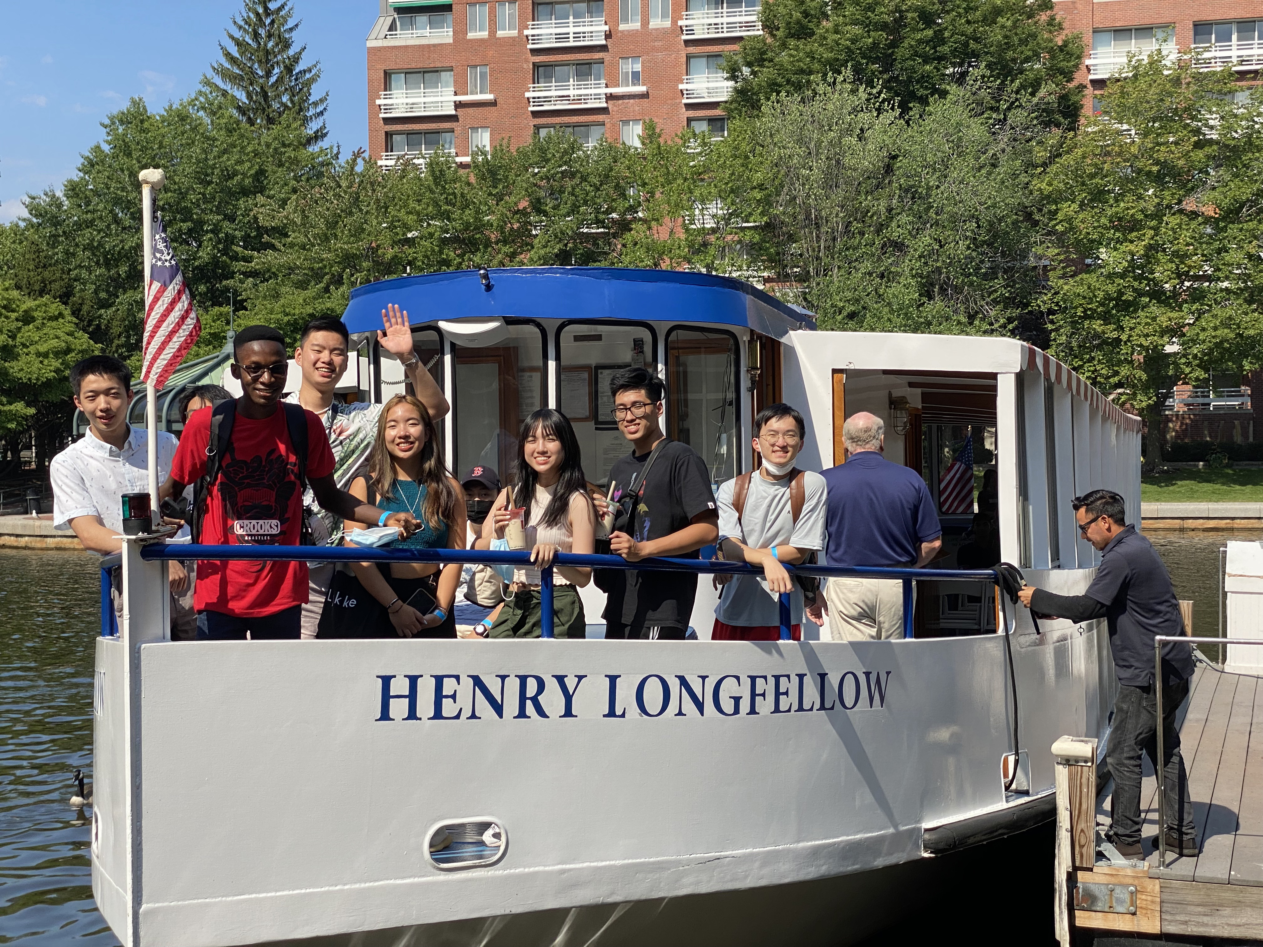 students on a boat waving