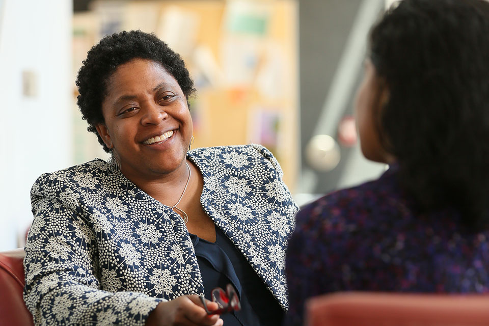 A Brandeis staff member talks with a student.