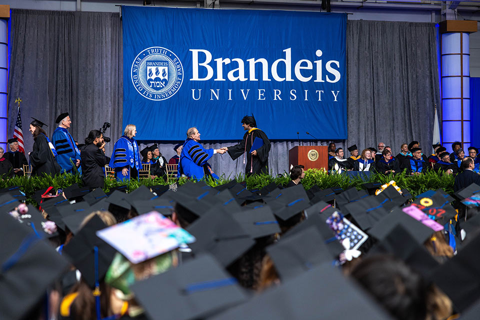 A student walks the stage during Commencement