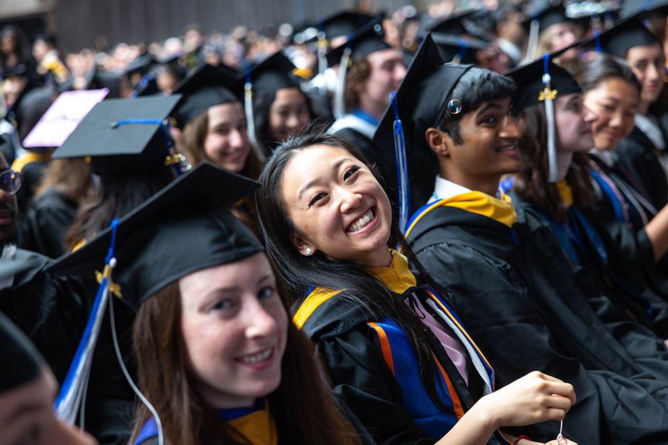 A graduate smiles during the ceremony