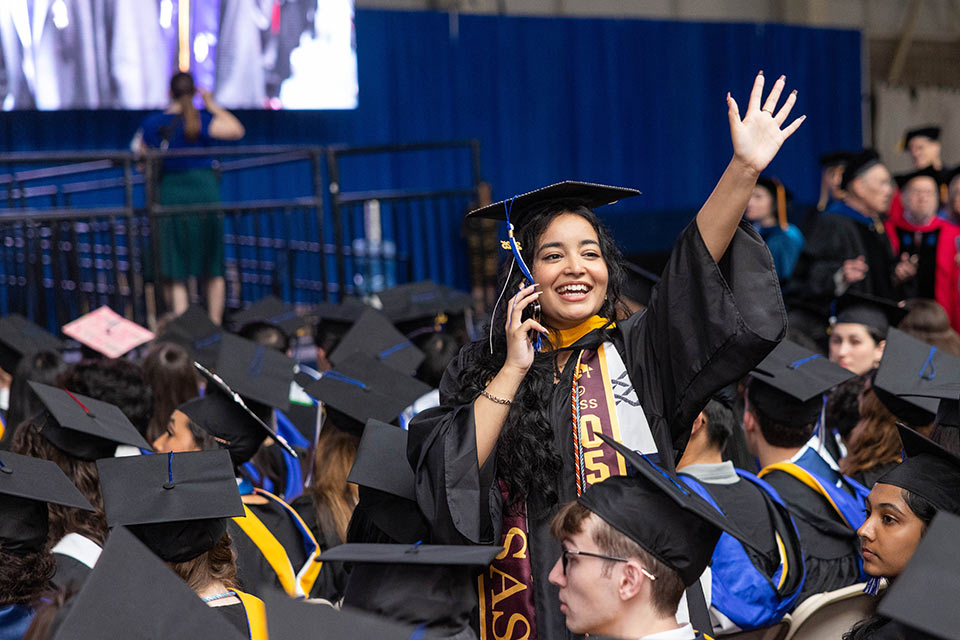 Graduates stand outside before the ceremony