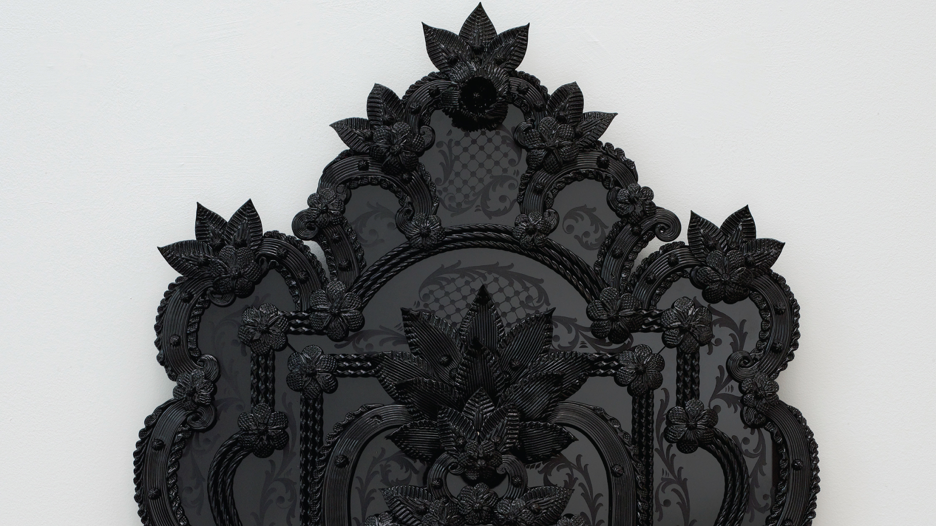 Antique black glass mirror in a Rococo style