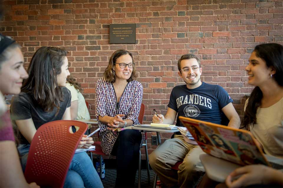 A professor and several students gathered in a discussion circle