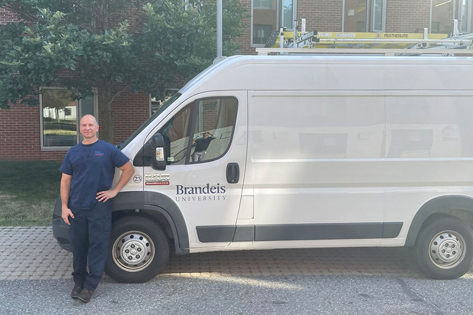 Person standing outside by a white truck