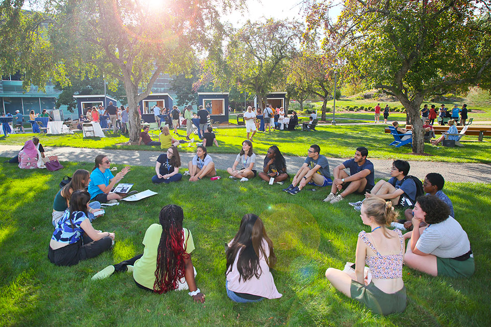 Group of new students sitting with an Orientation Leader