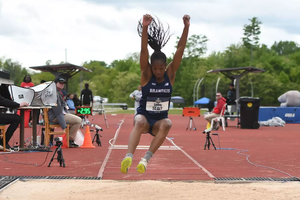 Sarai Sealy competing in the triple jump at a track meet.