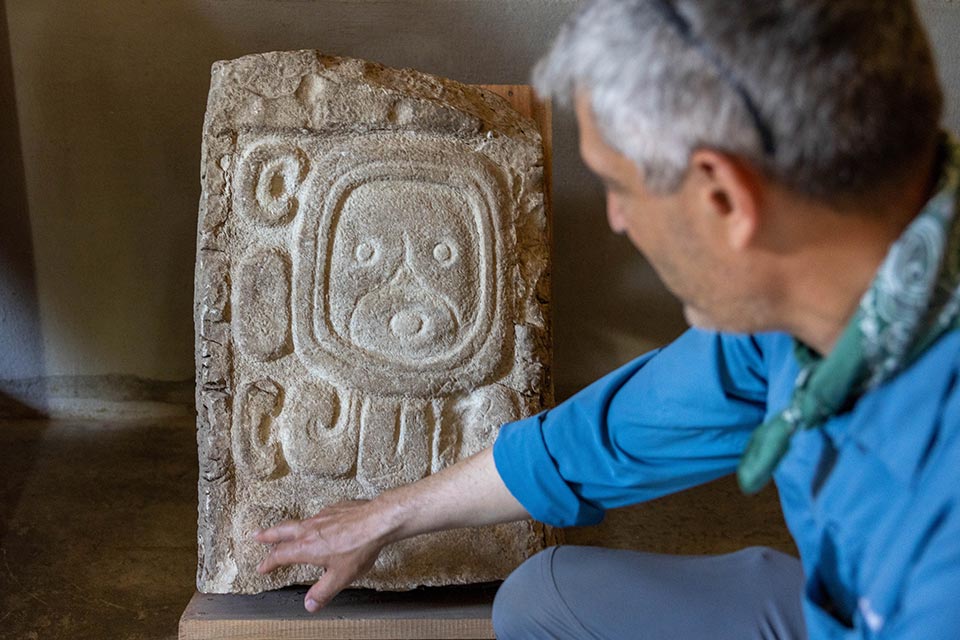 A Brandeis professor points at an archaeological artifact