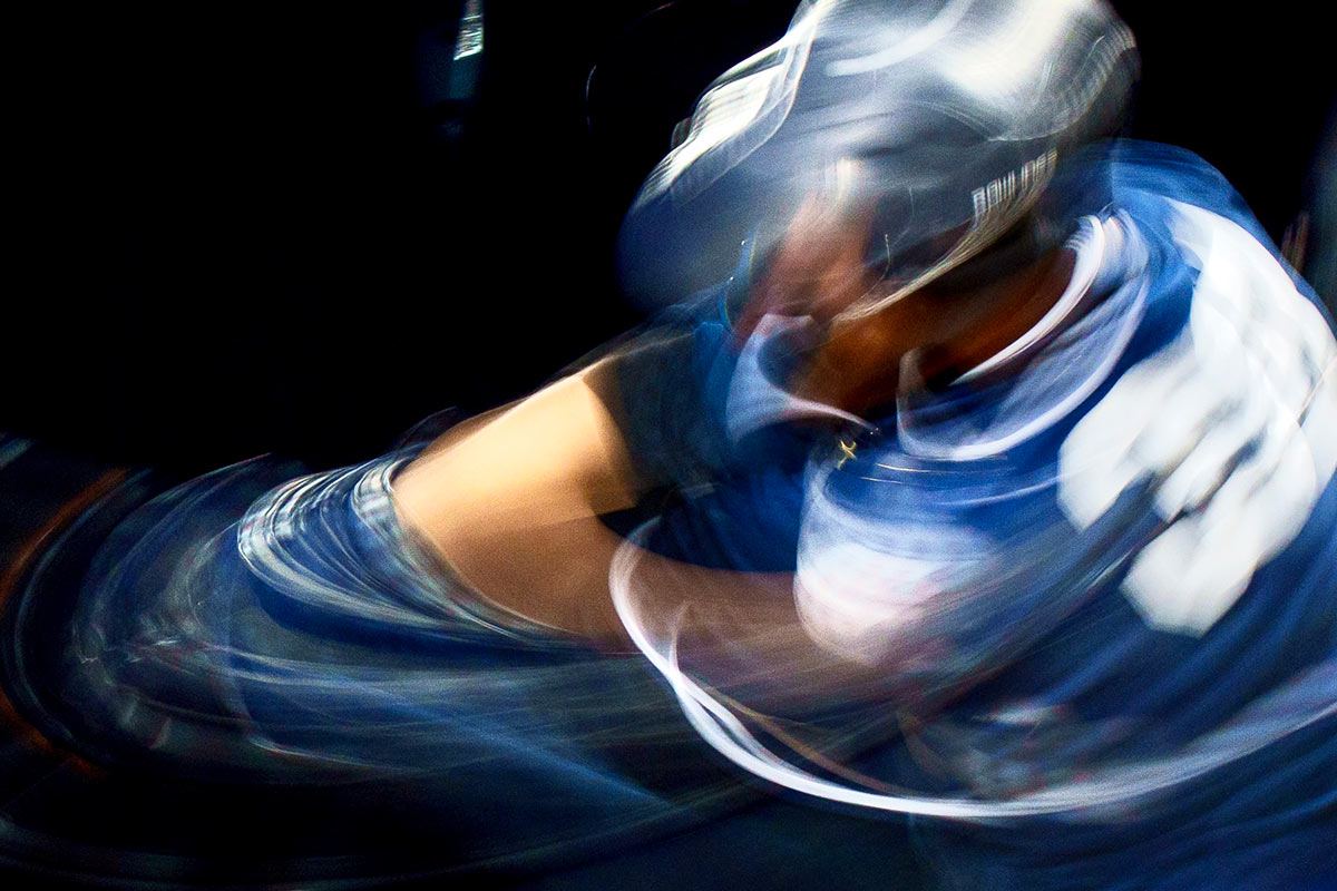 A blurry photo of a baseball player swinging a bat.