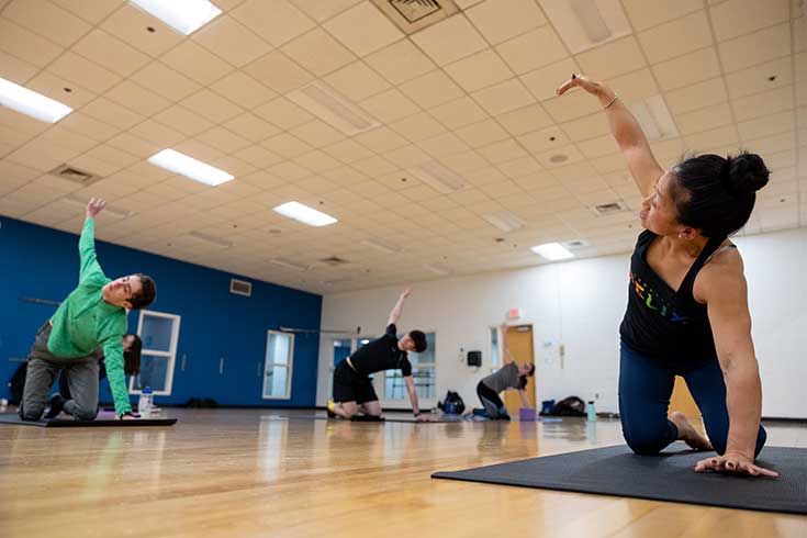 Three people practice yoga