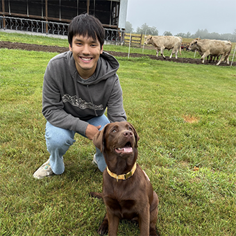 Photo of Gabe with a brown dog